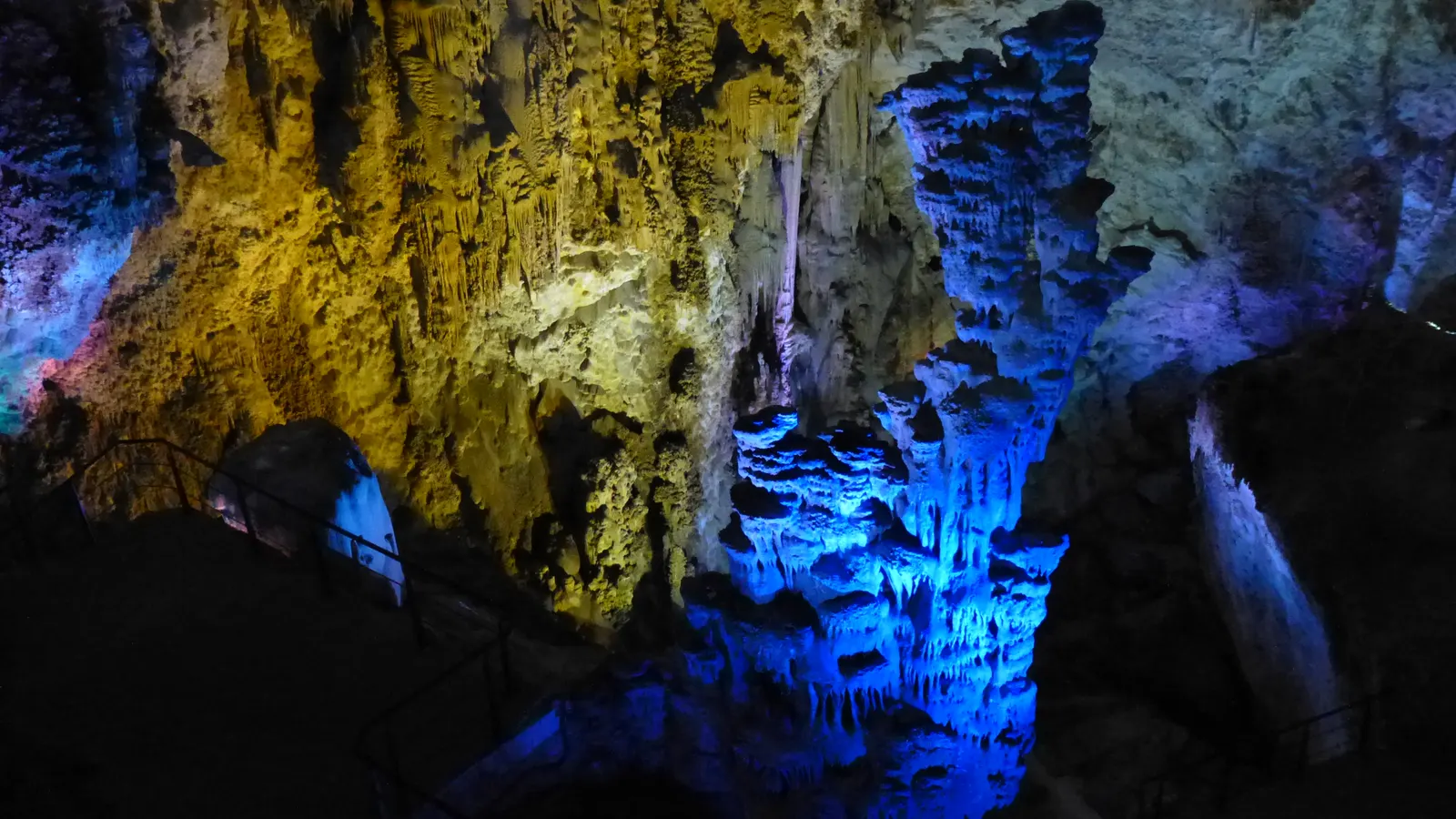 Coloured floodlights on the tall stalagmite columns in the main chamber of the Cuevas del Canelobre