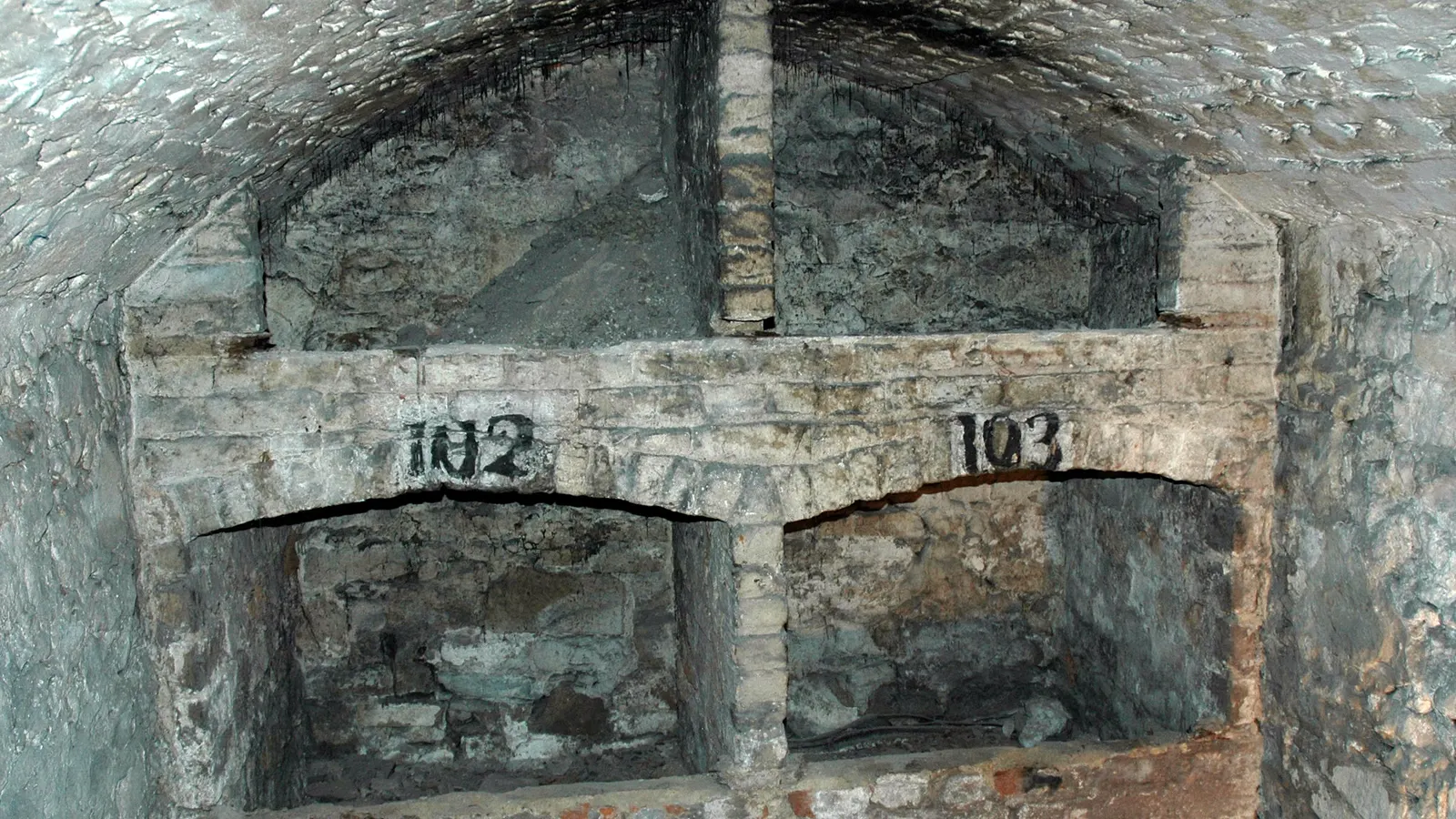 Brick chambers in the vaults under Edinburgh's South Bridge, numbers painted on the niches