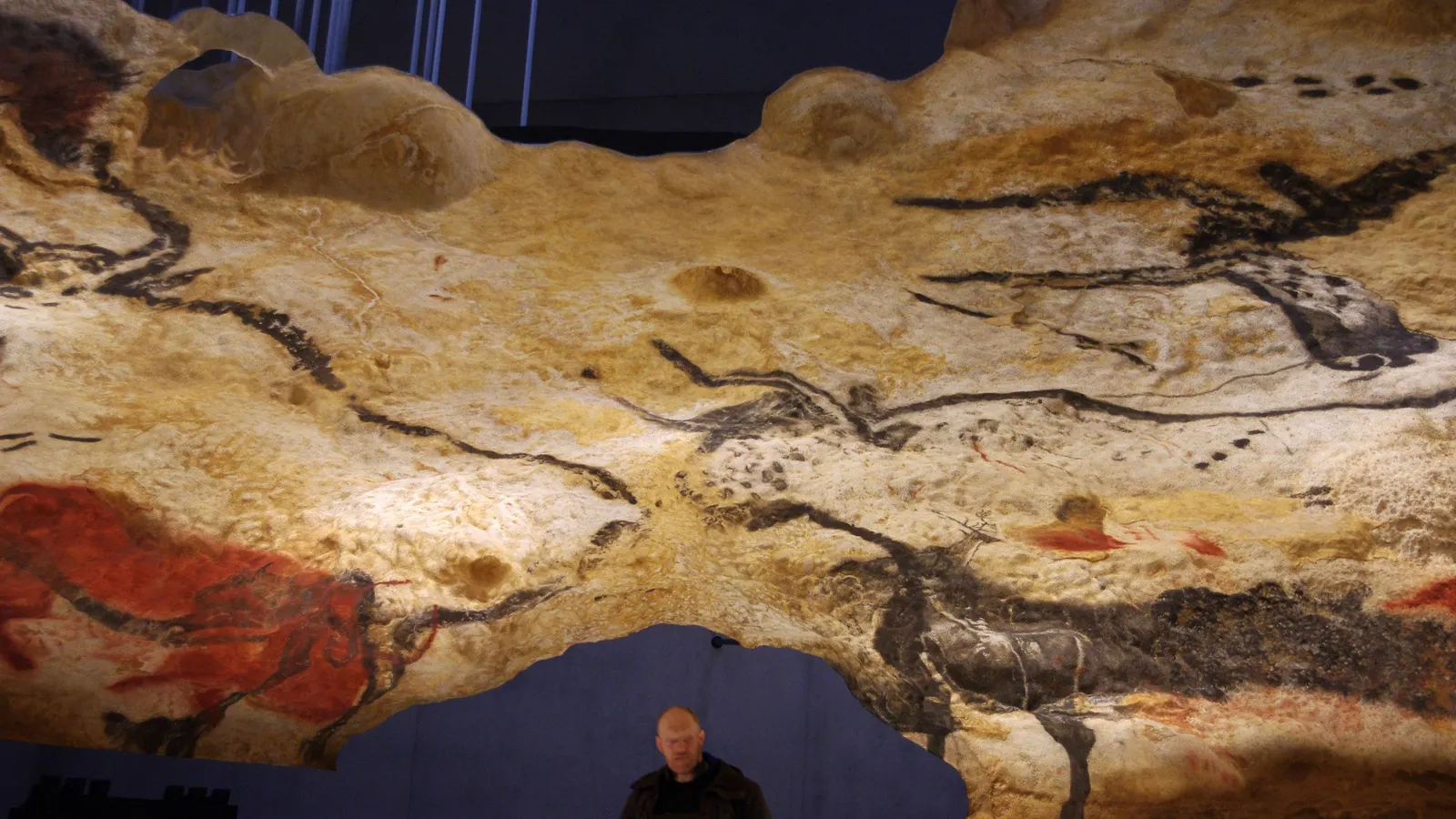 The replica of the Hall of the Bulls at Lascaux IV near Montignac, with a visitor below – the original cave has been closed since 1963