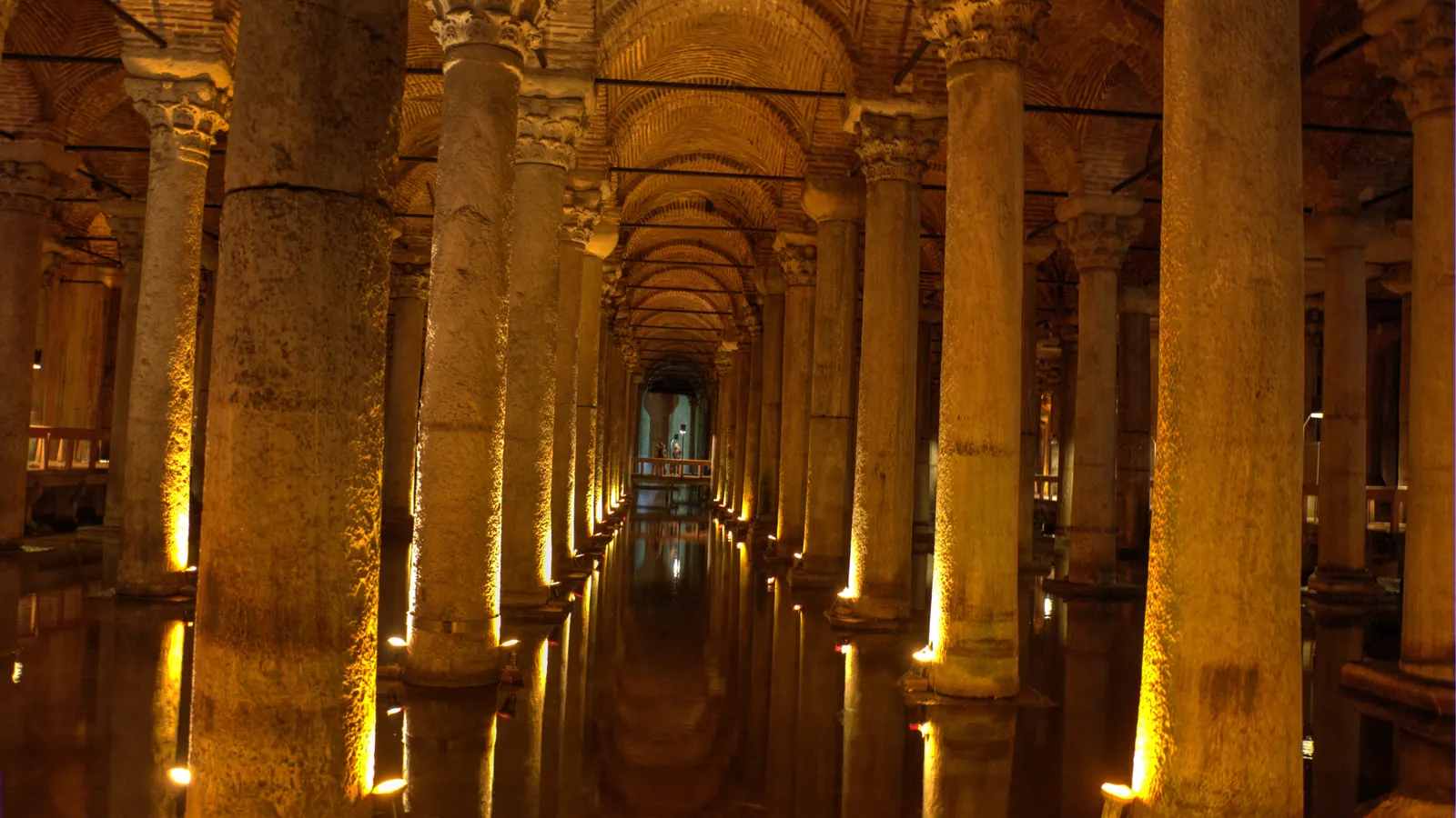 Rows of lit columns in the Basilica Cistern in Istanbul, reflections in the shallow water